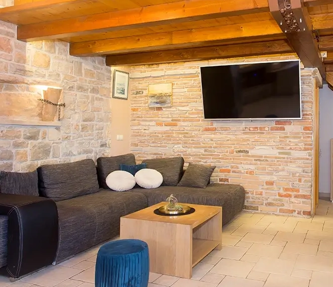 Living room with sofa, wooden and stone interior design